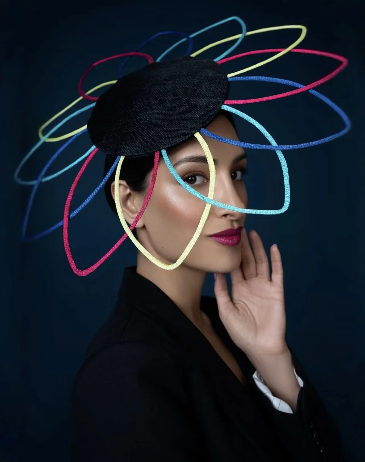 Model wearing a multicolour sculptural loop hat