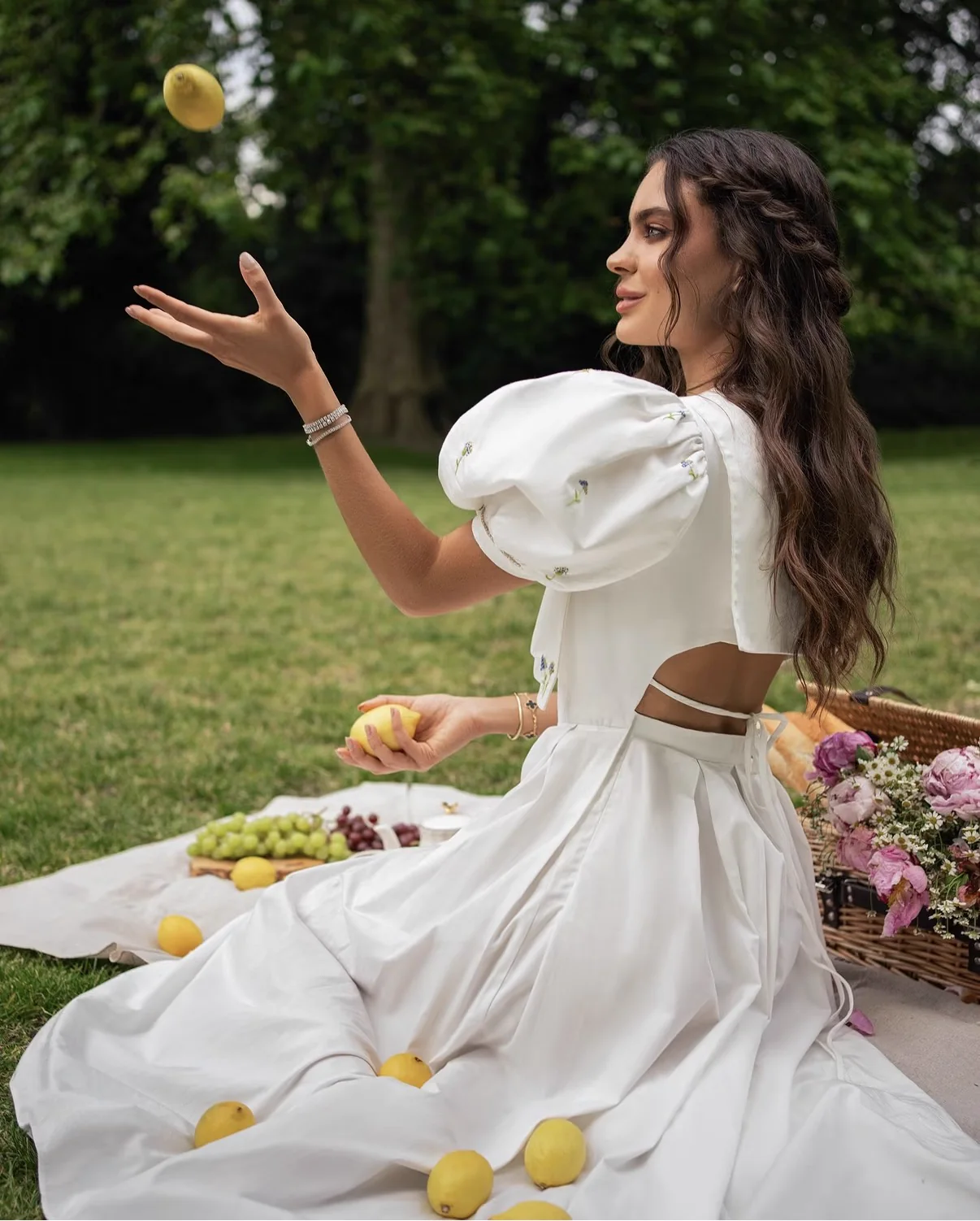 White fashion look at a garden picnic with lemons, photographed by Mariya Harley