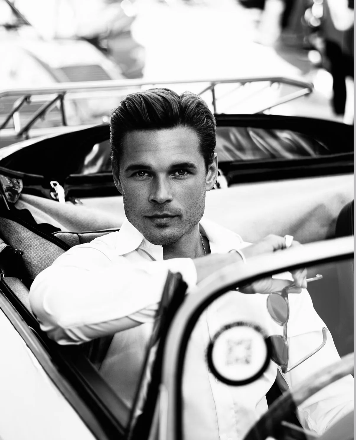 Black and white menswear portrait in a classic convertible, photographed by Mariya Harley