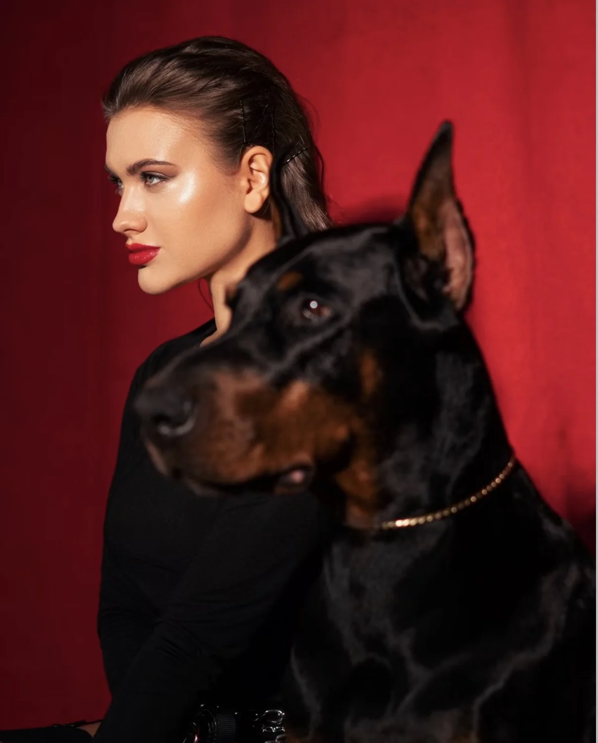 Red fashion editorial portrait with a Doberman