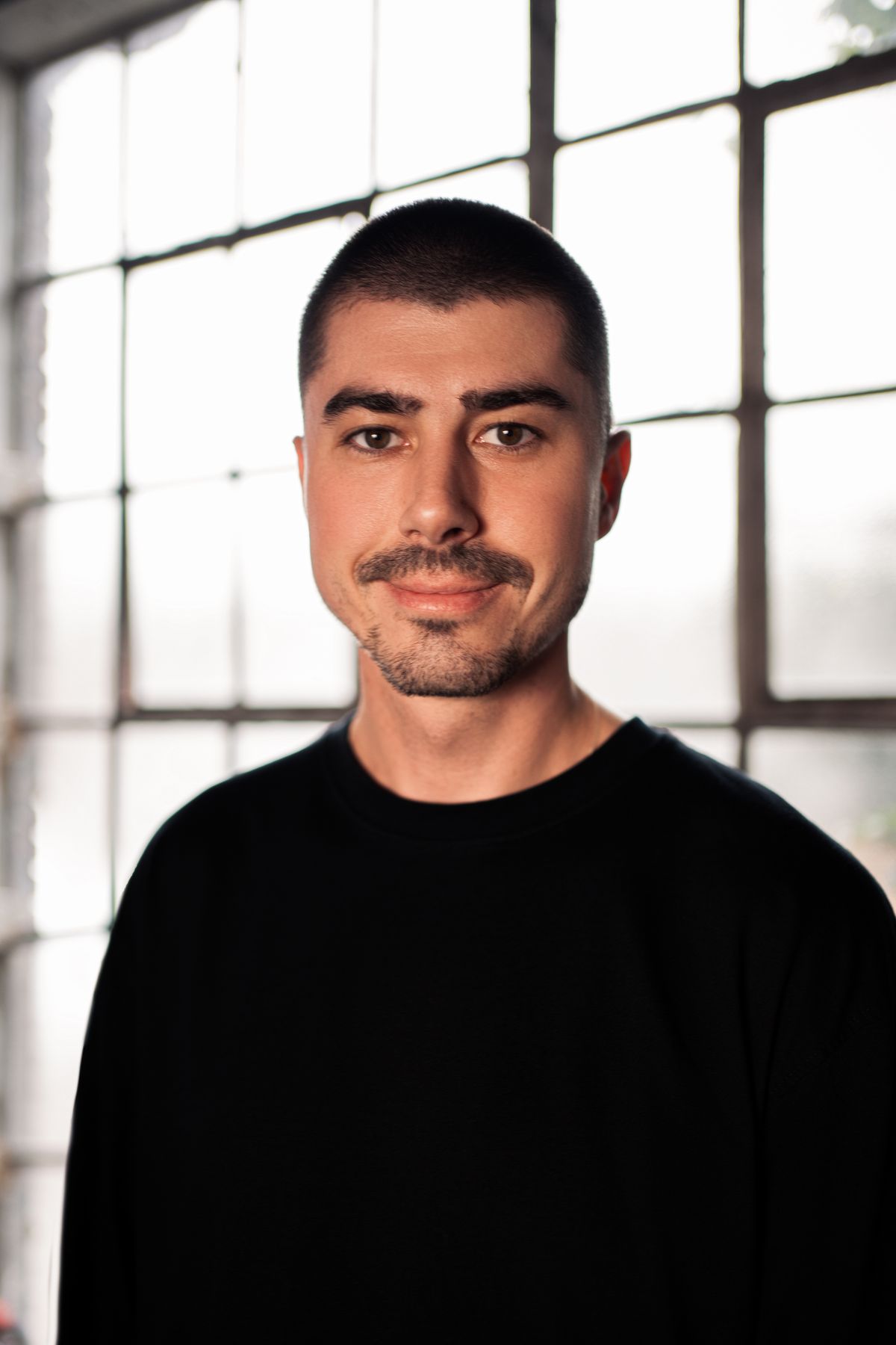 Natural-light headshot photographed against a window in London